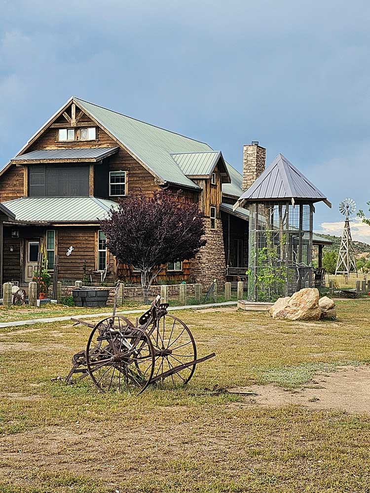 Rustic Ranch Cabin with Old Farm Equipment in Front Yard